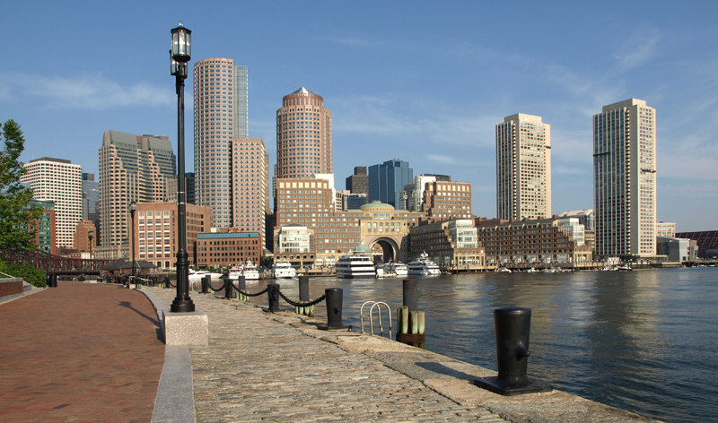 Boston Harbor waterfront with skyline in background (Image Credit: Tripcentral.ca)