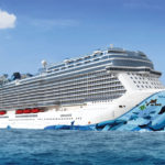 Norwegian Bliss ship on the ocean with blue sky in background