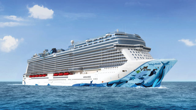 Norwegian Bliss ship on the ocean with blue sky in background